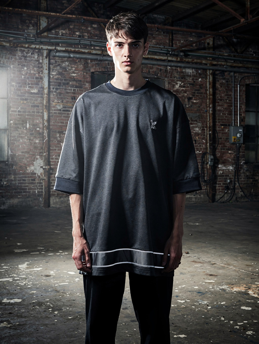 Front and back view of a black ARVÉ crewneck and sweatpants set with a chrome cursive logo and a large chrome AÉ monogram on the back