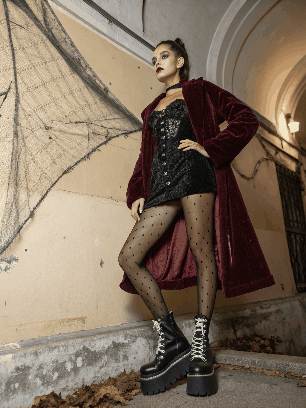 Models wearing ARVÉ dark romantic streetwear ensembles combining cropped hoodies with tiered ruffled skirts, leather belts and lace-up boots